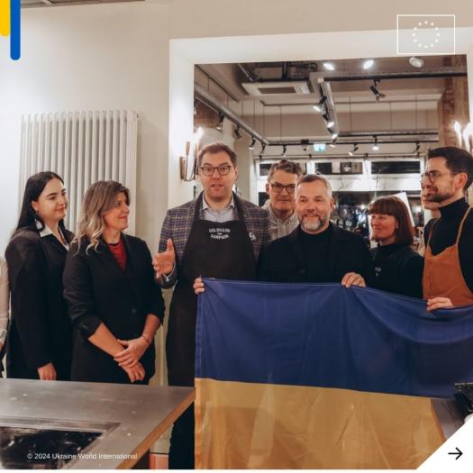 Picture of the team, holding a Ukrainian flag