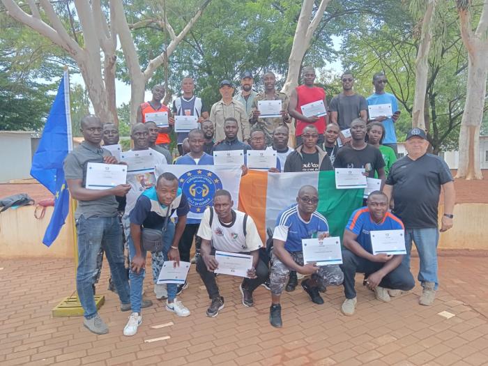A group of trainees receive certificate of completion.