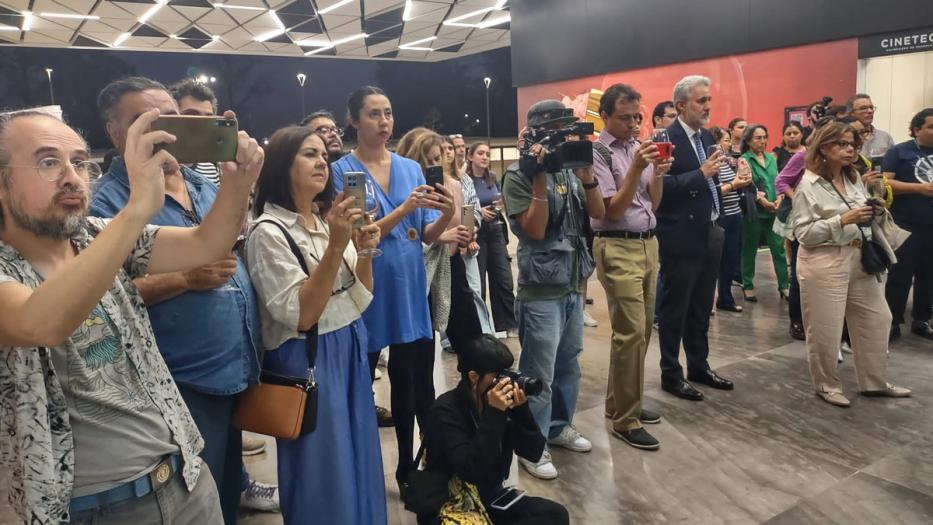 A crowd gathers to enjoy the launch of the exhibition. 