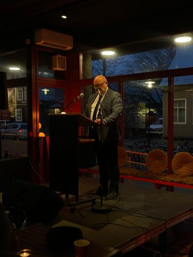 man speaking at a podium