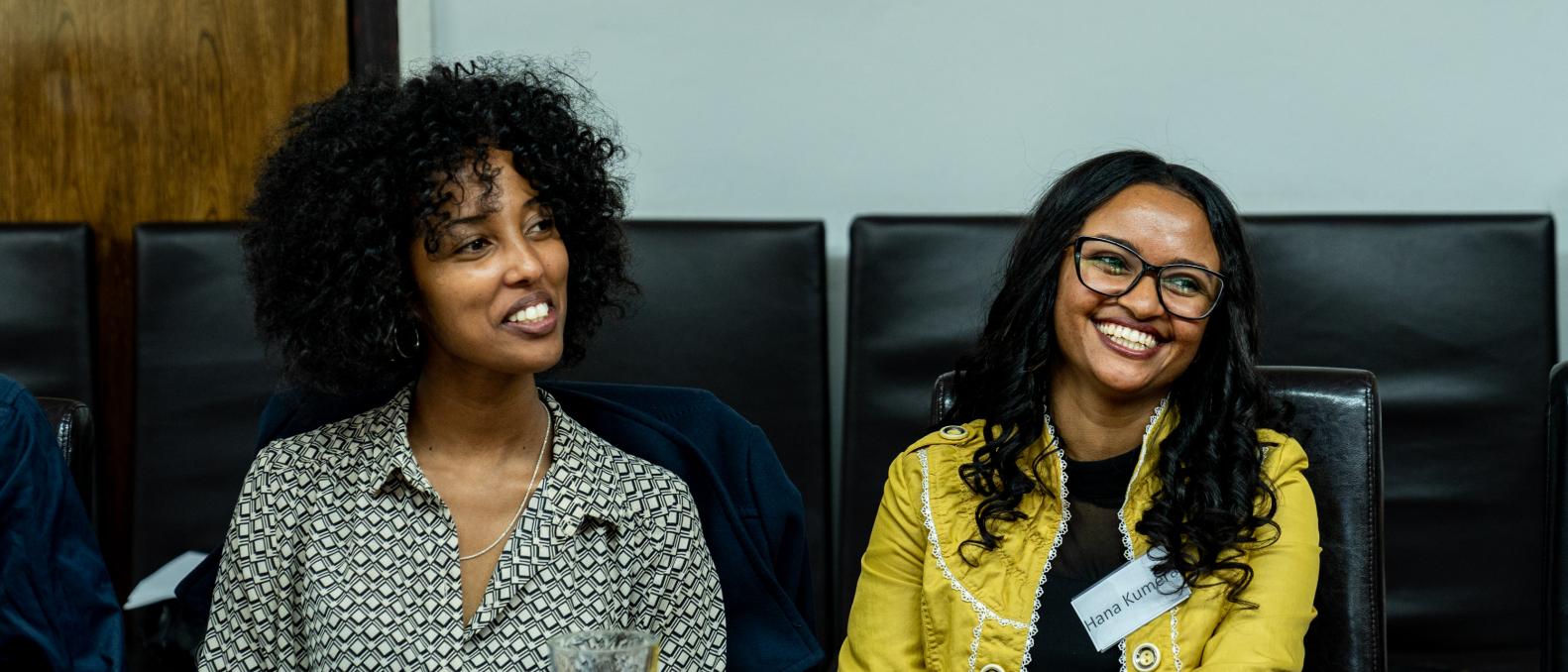Two people laughing in a meeting