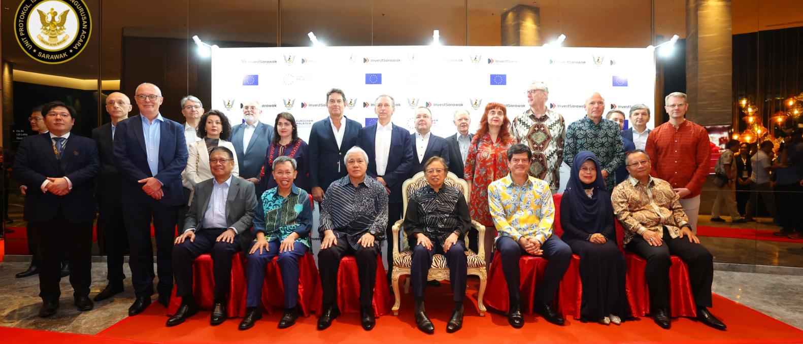 17 EU Ambassadors together with the Premier of Sarawak sitting in front of a backdrop