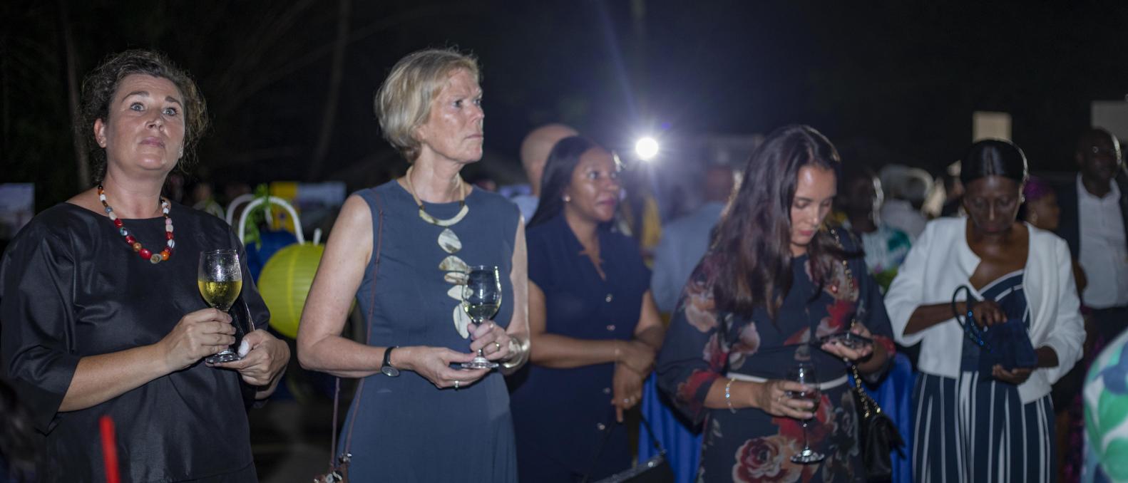 Attendees attentively listening to various speakers at the event 