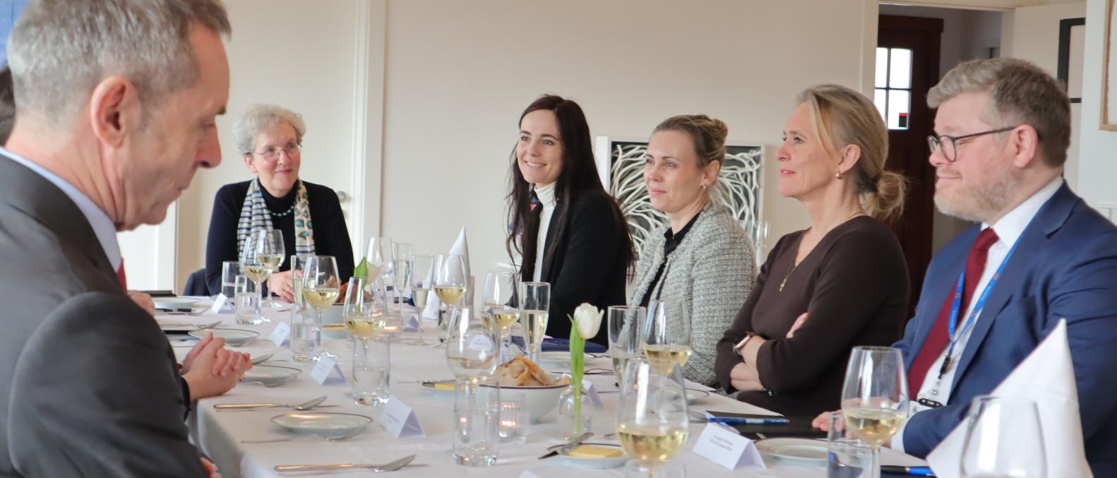 photo of six people sitting by a dining table