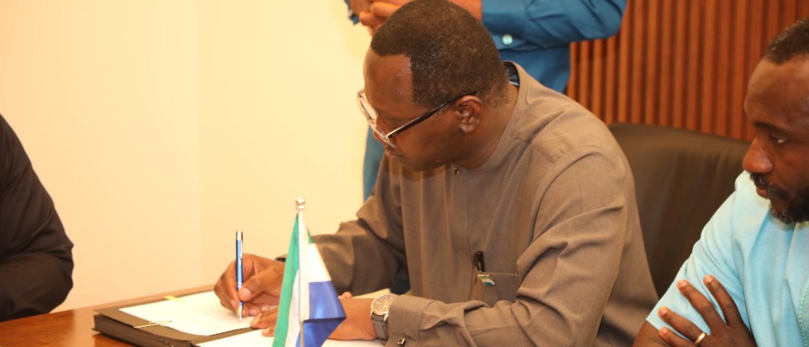 Minster of Finance, Sheku Fantamadi Bangura signing the financing agreement 