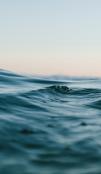 Body of Water Under Blue and White Skies