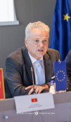 Ambassador Sattler sitting and speaking during the event