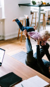 A woman playing with a child in a living room