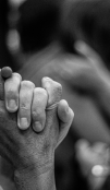 Black and white picture of two people holding hands