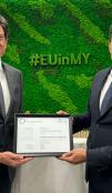 EU Ambassador Rokas displaying latest suistainability certificate