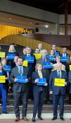 EU Ambassadors with different posters.