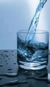A glass of water getting filled