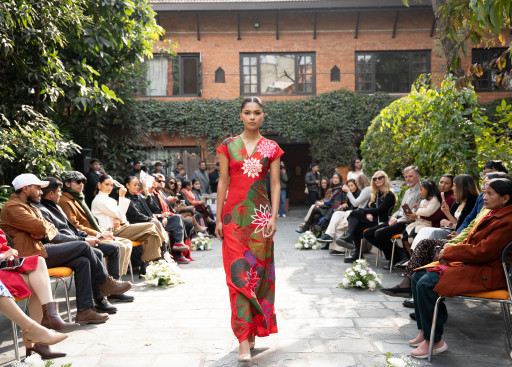 A model walks in a floral red dress.