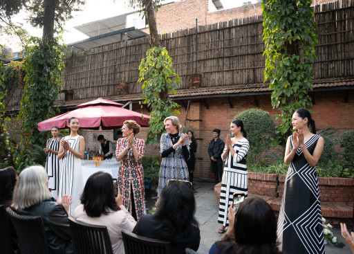 Models and designers walk the runway.