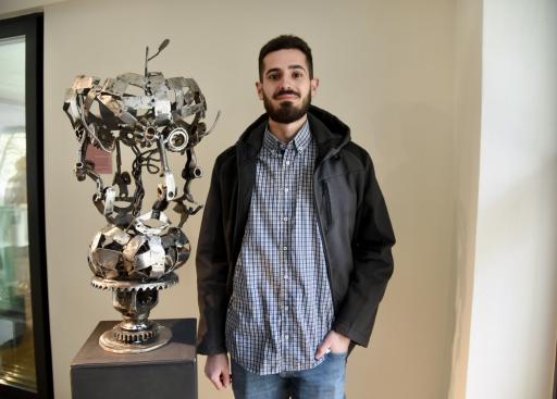 a man with an art sculpture 