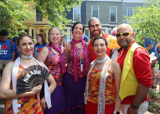 Four female and two male flamenco dancers pose for the camera.