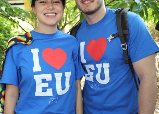Two people in "I Heart EU" T-shirts pose for the camera.