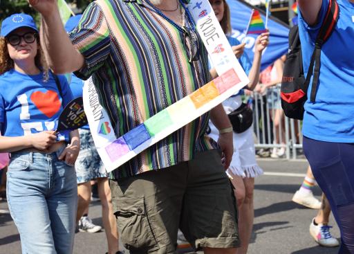 A bearded man waves a Swedish flag.