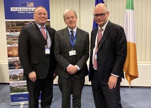 Three dignitaries in front of EU and Ireland flags