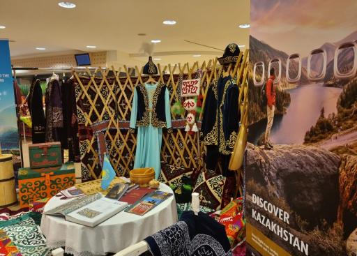 Banner 'Discover Kazakhstan', national clothes, blue dress, yurt and books