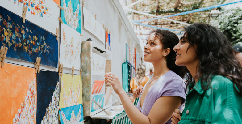 Two girls admiring artworks on the wall