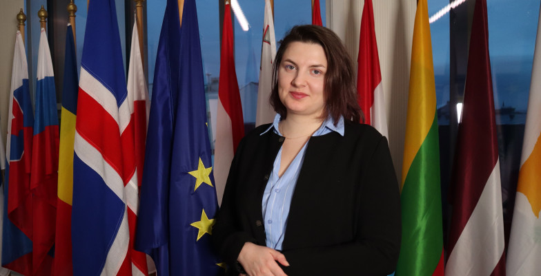 Weronika in front of flags