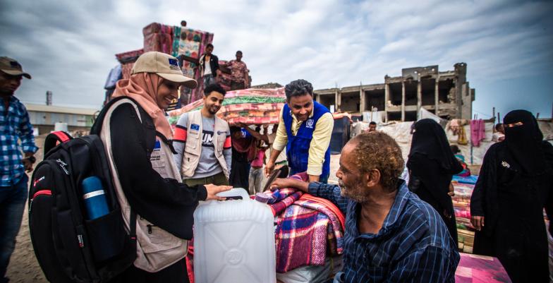 © IOM staff, and implementing partner in a joyful moment with Abdulhakem.