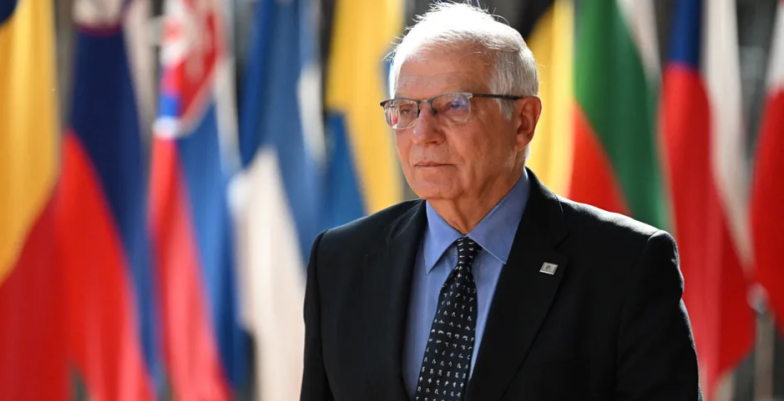 HR/VP Josep Borrell walking in front of EU flags