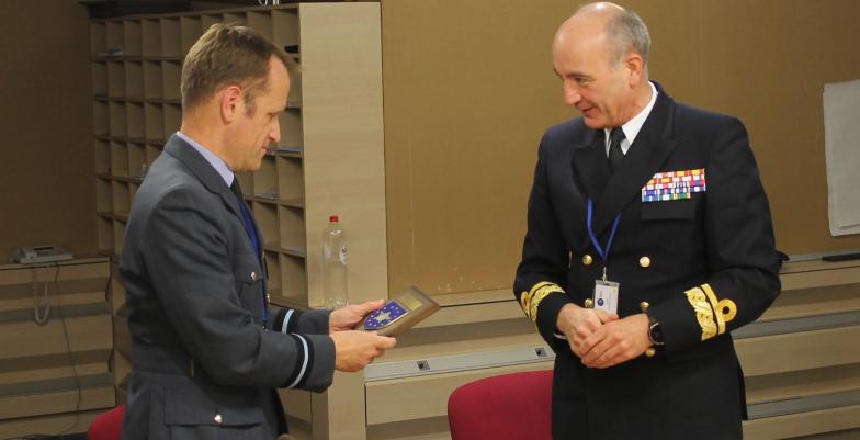 Rear Admiral Ignacio Cuartero Lorenzo make a presentation to Air Commodore Stephen Kelvington at the conclusion of the visit of the National Military Representative delegation SHAPE to the EUMS.