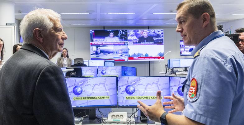 HRVP Josep Borrell at the inauguratin of the new crisis centre at the EEAS talking with a police offcer in front on several screens