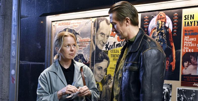 Cinematic photo of a couple at the entrance to a film theatre. 