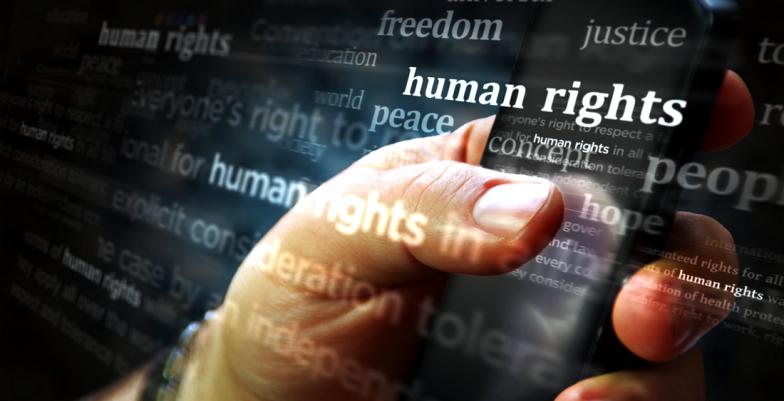 Hand holding internet device with Human Rights highlighted