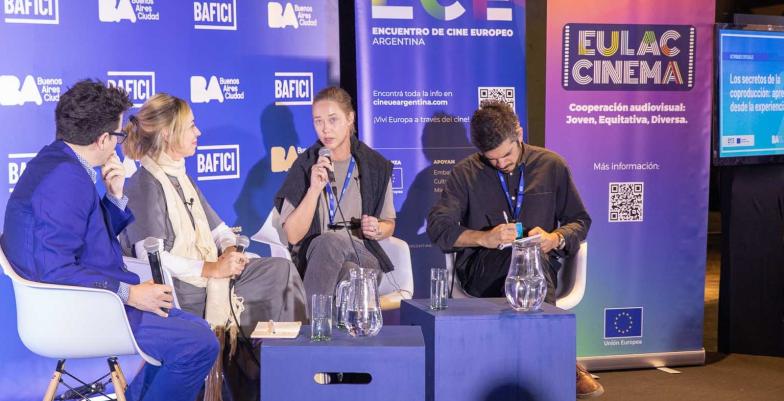 Filmmakers discuss their craft on a stage at a festival. 