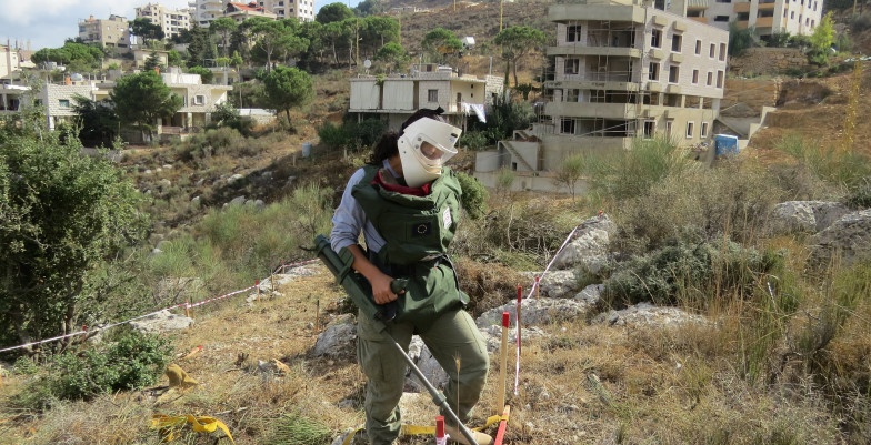 DCA Female deminer using the Vallon detector to locate land mines