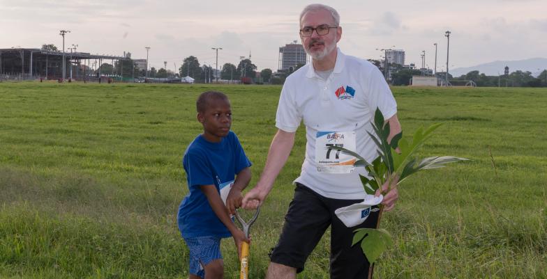 Ambassador Cavendish gets help to plant a tree at the EU 5K Run and Tree Planting event.