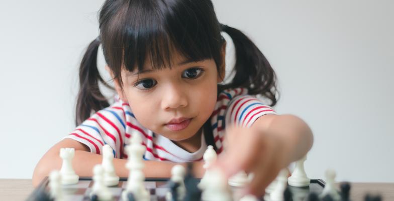 International Day of the Girl Child - Asian girl playing chess