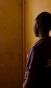 A person looking out of the window with their back to the camera