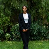 Girl on a black suit posing to the camera