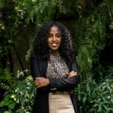 Curly hair girl, on formal clothes, posing to the camera