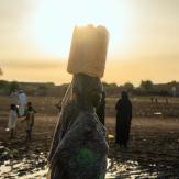 Woman with a bucket on her head