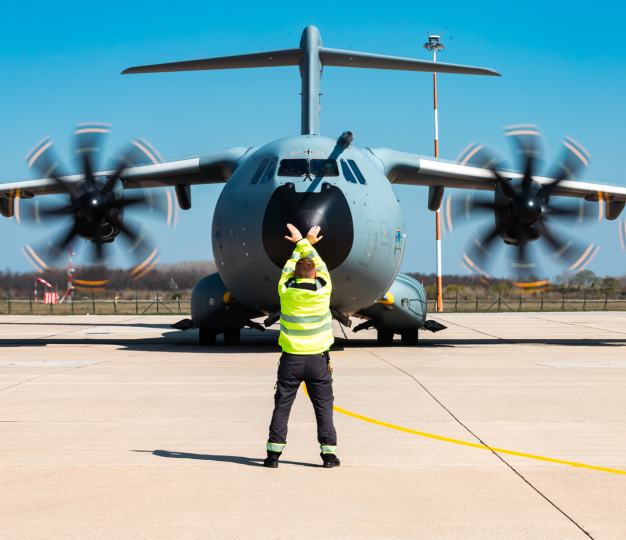 A person signalling to an aircraft