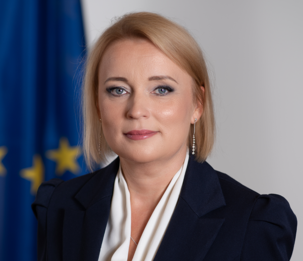Headshot of Jovita Neliupsiene with EU flag in the background.
