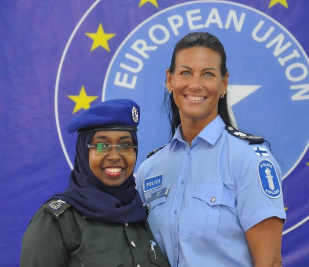 Two police generals in front of an EU flag
