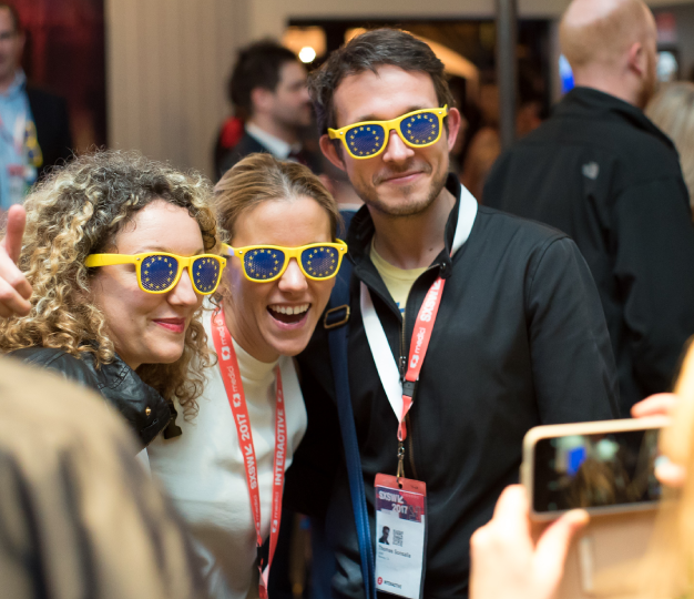 Three people wearing EU brand sunglasses pose for a photo.