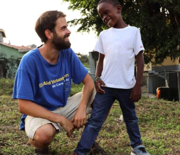 EU Aid Volunteer with child