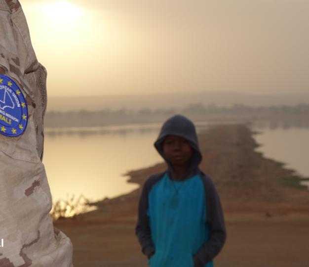 a little boy with a EUTM soldier