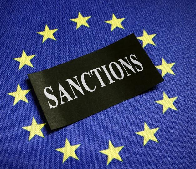 EU flag with sanctions text in the middle