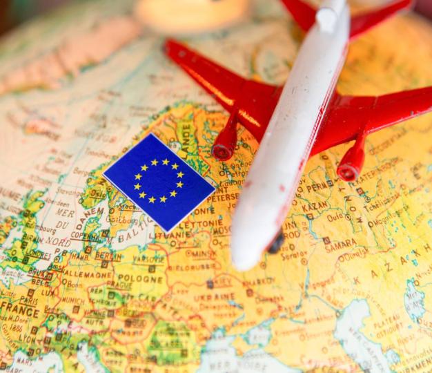 Toy plane sits atop map of Europe with EU flag